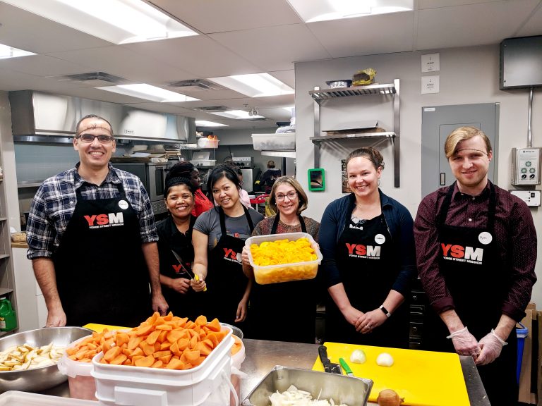 Helping families in need and adults experiencing chronic poverty by making meals as a group volunteer in Toronto