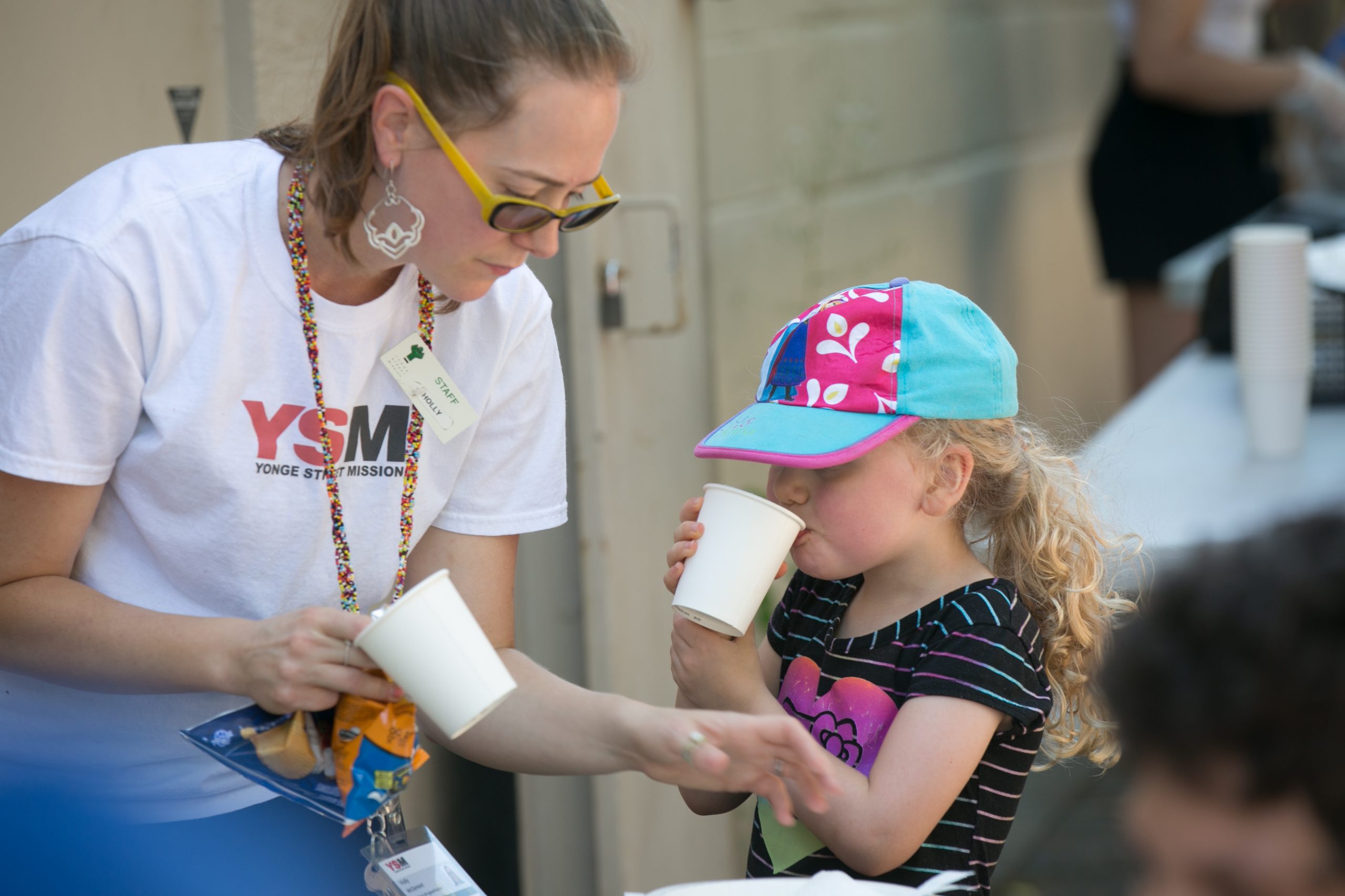 adult and child drinking lemonade at a YSM event
