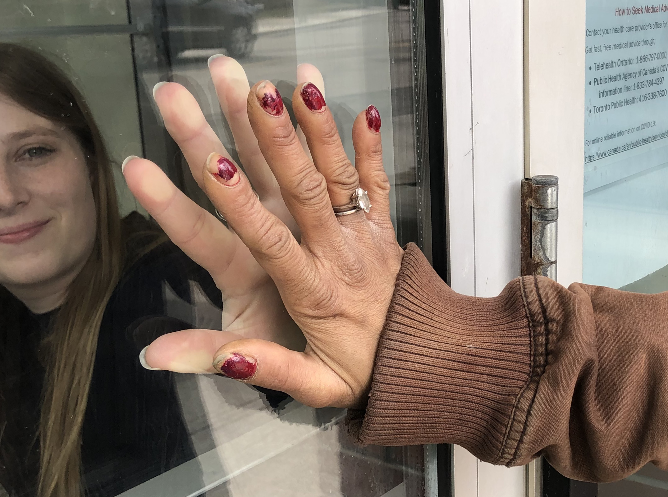 Hands touching through glass window