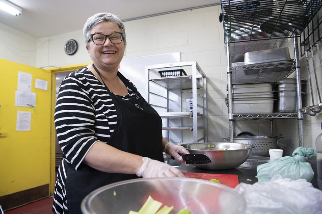Volunteer preparing a meal at the Davis Centre