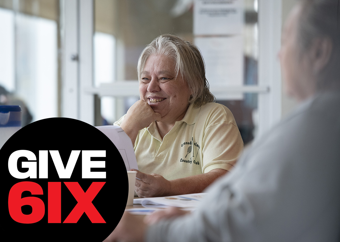 Happy woman in a life skills course with GIVE 6IX logo