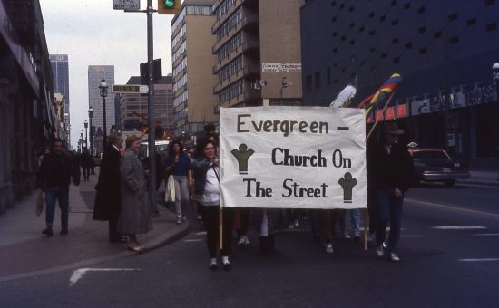 people holding a banner for church on the street